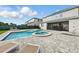 Beautiful backyard featuring a pool, spa, manicured lawn, and lounge chairs, ideal for outdoor enjoyment at 7682 Fairfax Dr, Kissimmee, FL 34747