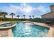 Beautiful pool and spa area featuring sun loungers and a dining table on the patio at 7682 Fairfax Dr, Kissimmee, FL 34747