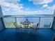 Balcony view with table and chairs overlooking the water at 13415 Blue Heron Beach Dr # 1006, Orlando, FL 32821