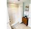 Bright bathroom with a shower-tub combo, tile floors and a coastal-themed art piece at 13415 Blue Heron Beach Dr # 1006, Orlando, FL 32821