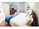Comfortable bedroom featuring a decorative headboard and light-colored walls with a dresser at 13415 Blue Heron Beach Dr # 1006, Orlando, FL 32821