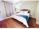 Cozy bedroom featuring a wrought iron bed frame and wood laminate flooring at 13415 Blue Heron Beach Dr # 1006, Orlando, FL 32821