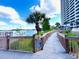 Waterfront boardwalk with dock rules provides access to stunning water views and building at 13415 Blue Heron Beach Dr # 1006, Orlando, FL 32821