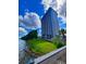 Waterfront view features lush green landscaping and the building with scenic water access at 13415 Blue Heron Beach Dr # 1006, Orlando, FL 32821