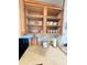 Kitchen cabinet featuring dishware, mugs, and small kitchen appliances at 13415 Blue Heron Beach Dr # 1006, Orlando, FL 32821
