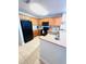 Open kitchen design with wooden cabinetry, black appliances, granite countertops, and tiled flooring at 13415 Blue Heron Beach Dr # 1006, Orlando, FL 32821