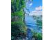 Lush greenery meets the serene lake, creating a tranquil and picturesque waterfront scene at 13415 Blue Heron Beach Dr # 1006, Orlando, FL 32821