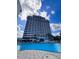Resort-style pool area with building and palm trees offers a luxurious experience at 13415 Blue Heron Beach Dr # 1006, Orlando, FL 32821