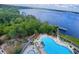 Aerial view of a resort style pool overlooking a lake at 13415 Blue Heron Beach Dr # 1006, Orlando, FL 32821