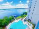 Aerial view of a resort style pool overlooking a lake at 13415 Blue Heron Beach Dr # 1006, Orlando, FL 32821