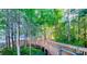 Elevated wooden walkway through a lush, green forested area provides unique access at 13415 Blue Heron Beach Dr # 1006, Orlando, FL 32821