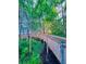 Elevated wooden walkway winds through lush foliage, providing serene access to the lake at 13415 Blue Heron Beach Dr # 1006, Orlando, FL 32821