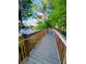 Scenic wooden walkway with railings offers a tranquil path through the lush landscape at 13415 Blue Heron Beach Dr # 1006, Orlando, FL 32821