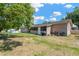 Large backyard featuring lush green grass and mature trees at 211 Nw 8Th St, Mulberry, FL 33860
