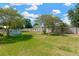 Spacious backyard featuring green grass, above ground pool, and mature trees at 211 Nw 8Th St, Mulberry, FL 33860