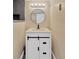 Cozy bathroom featuring a round mirror and vanity with black hardware at 211 Nw 8Th St, Mulberry, FL 33860