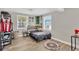 Bright bedroom with light gray walls, wood-look floors, and two windows for natural light at 211 Nw 8Th St, Mulberry, FL 33860
