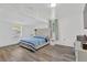 Spacious bedroom featuring a large bed, light wood flooring, and windows for natural lighting at 211 Nw 8Th St, Mulberry, FL 33860