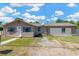 Charming single story home with neutral exterior, driveway, sidewalk, and partially-landscaped front yard at 211 Nw 8Th St, Mulberry, FL 33860
