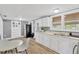 Well-lit kitchen with white cabinets, stainless steel appliances, and adjacent dining area at 211 Nw 8Th St, Mulberry, FL 33860