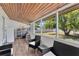 Enclosed porch featuring wood ceiling, light wood floors, and outdoor backyard views at 211 Nw 8Th St, Mulberry, FL 33860