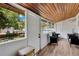 Enclosed porch featuring wood ceiling, light wood floors, and outdoor backyard views at 211 Nw 8Th St, Mulberry, FL 33860
