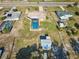 Aerial view of the home featuring a large screened pool at 6531 Red Grange Blvd, Indian Lake Estates, FL 33855