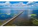 Expansive aerial view of a long pier stretching into a large body of water at 6531 Red Grange Blvd, Indian Lake Estates, FL 33855