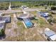 Wide aerial view showing the pool and proximity to the green space at 6531 Red Grange Blvd, Indian Lake Estates, FL 33855