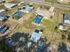 Aerial view of the home with a screened lanai and pool at 6531 Red Grange Blvd, Indian Lake Estates, FL 33855