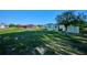 Large backyard featuring grass, a storage shed, and view of screened in porch at 6531 Red Grange Blvd, Indian Lake Estates, FL 33855