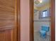 Bathroom view from the hallway, featuring colorful tile and fixtures at 6531 Red Grange Blvd, Indian Lake Estates, FL 33855