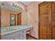 Bathroom with a vanity, mirror, and view of toilet and sink at 6531 Red Grange Blvd, Indian Lake Estates, FL 33855