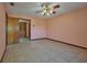 Bedroom with tile flooring, ceiling fan, neutral walls, and a closet at 6531 Red Grange Blvd, Indian Lake Estates, FL 33855