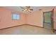 Bedroom featuring tile flooring, ceiling fan, and neutral walls, with a window view at 6531 Red Grange Blvd, Indian Lake Estates, FL 33855