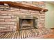 Close up of the fireplace with an open glass door and a decorative stone surround at 6531 Red Grange Blvd, Indian Lake Estates, FL 33855