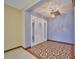 Foyer featuring tiled flooring, chandelier, and sidelights that enhance the entrance's appeal at 6531 Red Grange Blvd, Indian Lake Estates, FL 33855