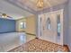 Foyer with tiled flooring and sidelights, creating a welcoming entrance to the home at 6531 Red Grange Blvd, Indian Lake Estates, FL 33855