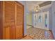 Foyer with tiled flooring, natural lighting, and a coat closet at 6531 Red Grange Blvd, Indian Lake Estates, FL 33855