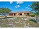A single-story home featuring a stucco exterior, stone accents, and a well-maintained front lawn at 6531 Red Grange Blvd, Indian Lake Estates, FL 33855