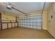Clean garage with door closed, features an automatic door opener and storage cabinets along the back wall at 6531 Red Grange Blvd, Indian Lake Estates, FL 33855