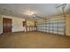This garage features epoxy flooring, storage, overhead lighting, and electric garage door opener at 6531 Red Grange Blvd, Indian Lake Estates, FL 33855