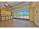 Spacious garage featuring epoxy flooring, storage cabinets, and glass doors with a view to the outside at 6531 Red Grange Blvd, Indian Lake Estates, FL 33855