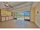 Spacious garage with built-in storage cabinets, pegboard, and screen door for ventilation and natural light at 6531 Red Grange Blvd, Indian Lake Estates, FL 33855