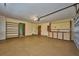 This garage features epoxy flooring, storage, overhead lighting, and interior access at 6531 Red Grange Blvd, Indian Lake Estates, FL 33855