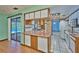 Open kitchen featuring stainless steel appliances, white cabinetry, and a breakfast bar overlooking a pool at 6531 Red Grange Blvd, Indian Lake Estates, FL 33855
