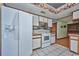 Bright kitchen with modern appliances, tile floors, and white cabinetry at 6531 Red Grange Blvd, Indian Lake Estates, FL 33855