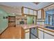 Kitchen featuring a breakfast bar, open to living area and pool access at 6531 Red Grange Blvd, Indian Lake Estates, FL 33855