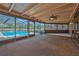 Enclosed lanai featuring a ceiling fan, ample space, and a view of the pool at 6531 Red Grange Blvd, Indian Lake Estates, FL 33855