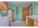 This laundry room features a washer, dryer, utility sink, and hot water heater at 6531 Red Grange Blvd, Indian Lake Estates, FL 33855